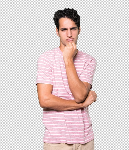 Angry young man posing against background