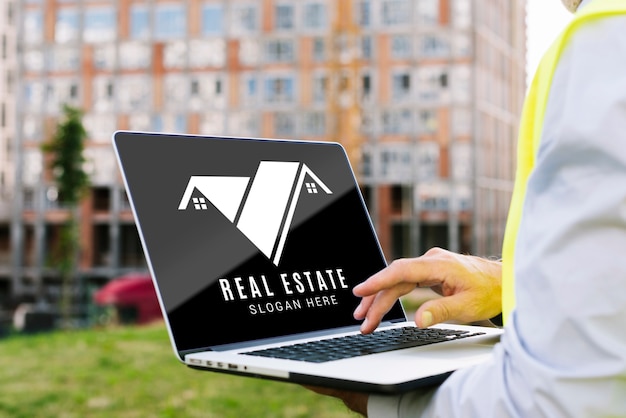 Architect holding a laptop mock-up