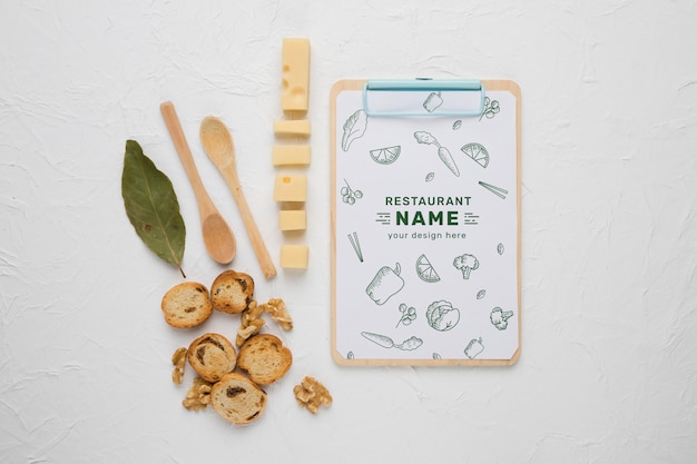 Arrangement of delicious foods with clipboard mock-up