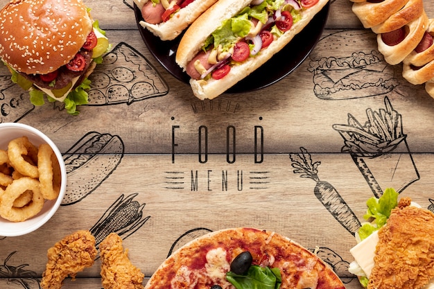 Arrangement of fast food on wooden background