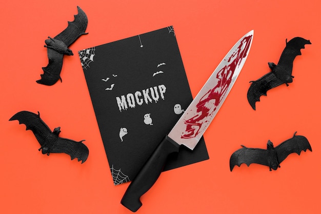 Arrangement with bats and bloody knife