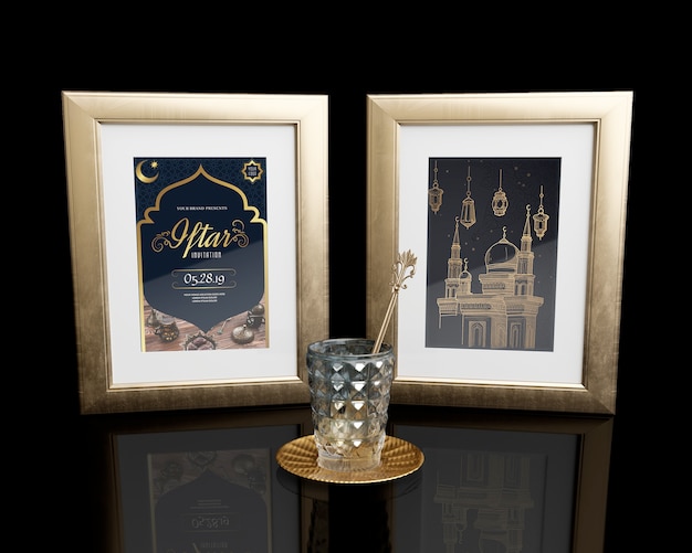 arrangement with frames and glass on black table