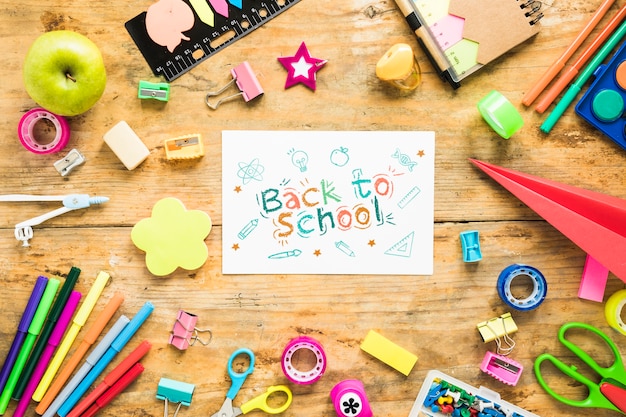 Arrangement with supplies for school on wooden background