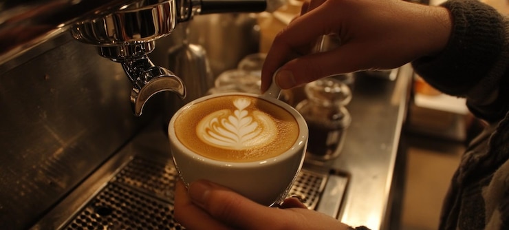 PSD artisan coffee creation latte art in a cozy cafe