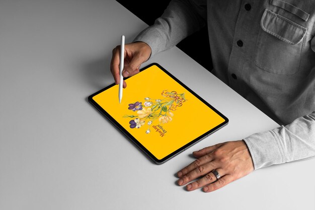 artist sketching on a tablet with a stylus