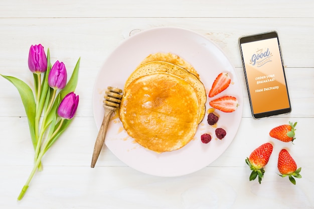 Assortment of breakfast pancakes next to smartphone