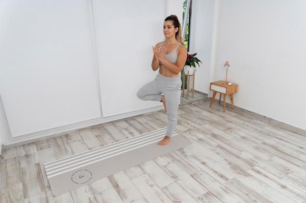 PSD athletic woman doing yoga at home