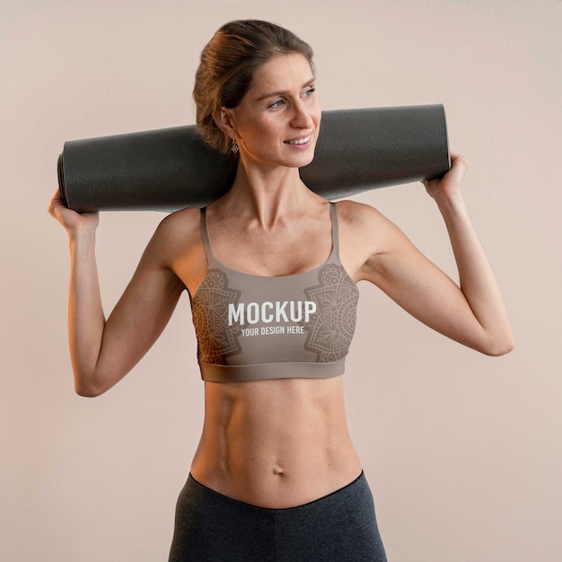 Athletic woman holding yoga mat