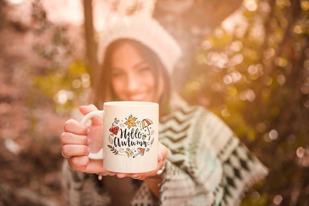 Autumn concept with woman holding mug