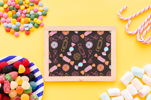 back to school composition with slate and sweets