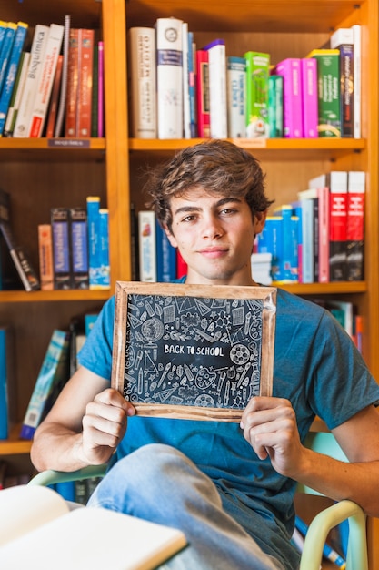 back to school concept with boy showing slate