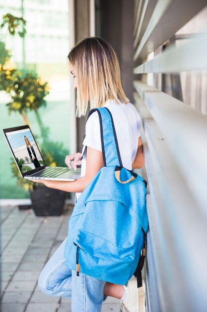 Back to school concept with girl using laptop