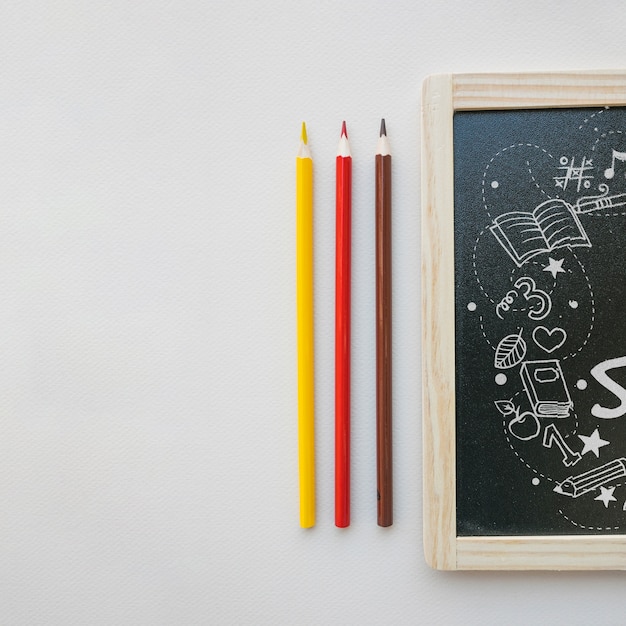 back to school mockup with slate next to pencils