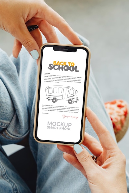 Back to school poster on a photo of a hand holding a smartphone