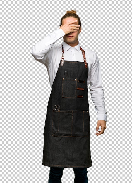 PSD barber man in an apron covering eyes by hands. do not want to see something