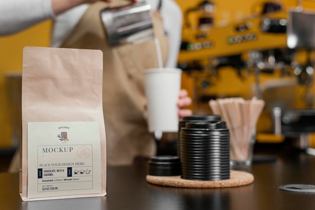 PSD barista working near coffee packaging mockup