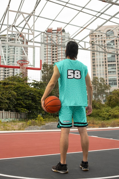 PSD basketball player wearing jersey mock-up design outdoors on the court
