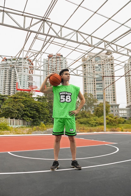 Basketball player wearing jersey mock-up design outdoors on the court