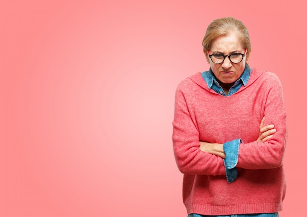 PSD beautiful senior woman looking angry, unhappy and frustrated, gesturing furiously, with arms crossed