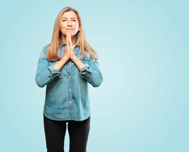 PSD beautiful senior woman praying in a saintly manner, begging