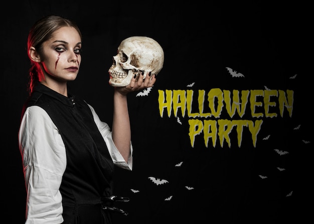 PSD beautiful woman with make-up as blood holding a skull