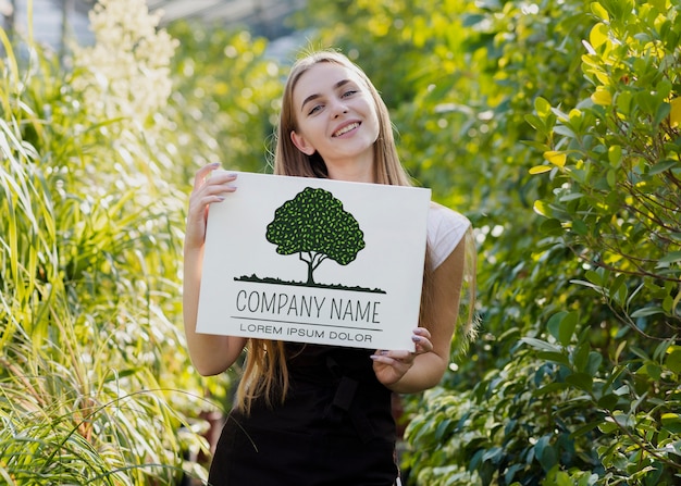 Beautiful young girl surrounded by plants