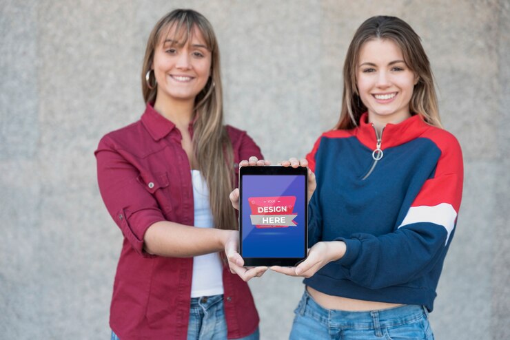 PSD beautiful young girls holding a tablet