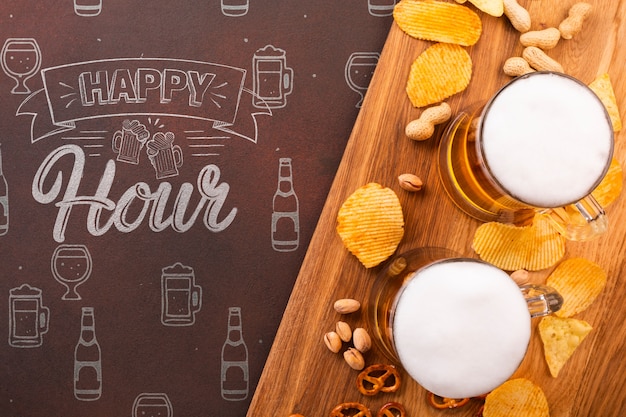 Beer mugs on wooden tray with chips