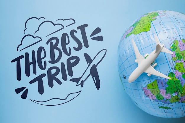 PSD the best trip lettering with earth globe and airplane toy