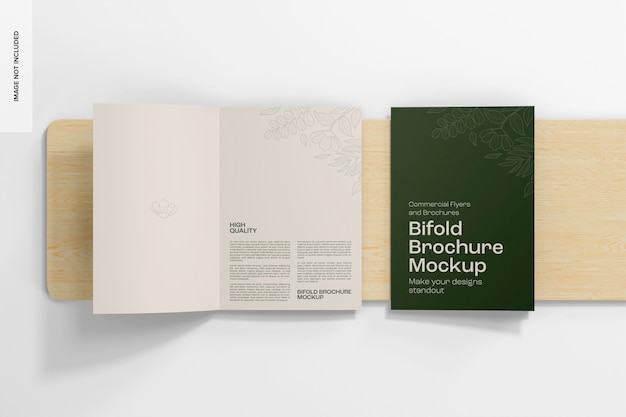 Bifold brochures on wooden podium mockup top view