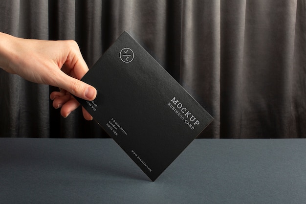 Big paper business card mock-up with draping fabric background