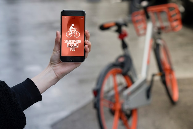 PSD bike riding concept hand holding smartphone