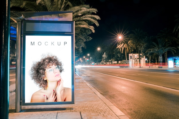 PSD billboard mockup at bus stop at night