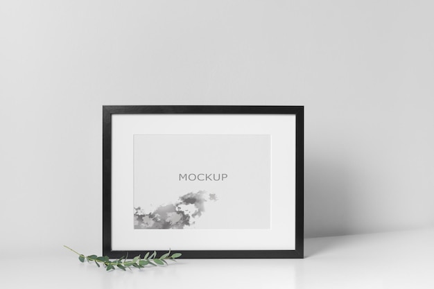 Black art frame mockup in white room interior