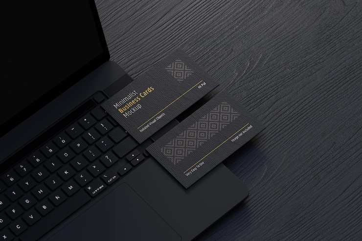 PSD black business cards mockup on laptop device