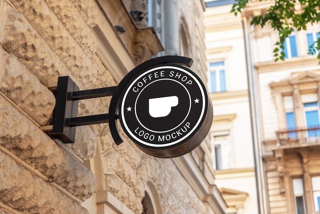 Black circle logo sign mockup stands in a modern city street