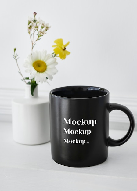 PSD black coffee cup mockup daisies in a vase