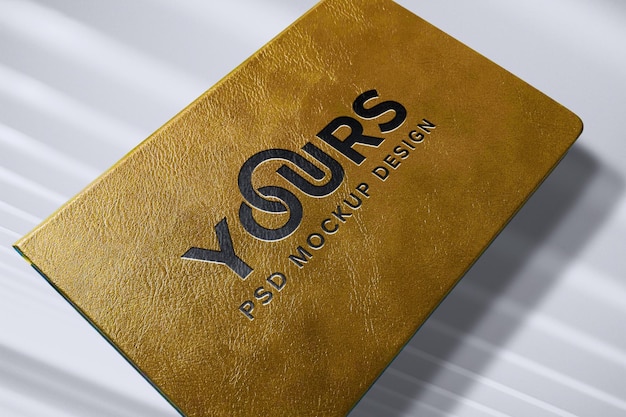 Black logo mockup on luxury gold book cover