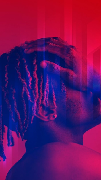 black man covering his face on a red background