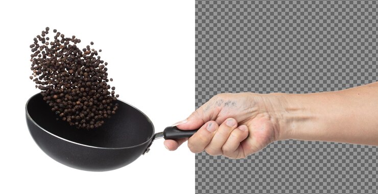 PSD black pepper seeds fly throw up in pan black pepper float explode abstract cloud fly black peppercorn splash throwing in air white background isolated high speed shutter freeze motion