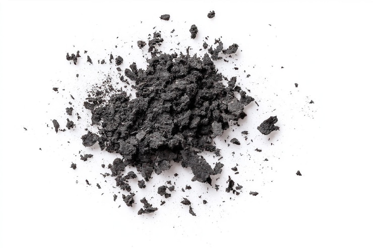PSD black powder specks scattered on isolated transparent background closeup view of powder form