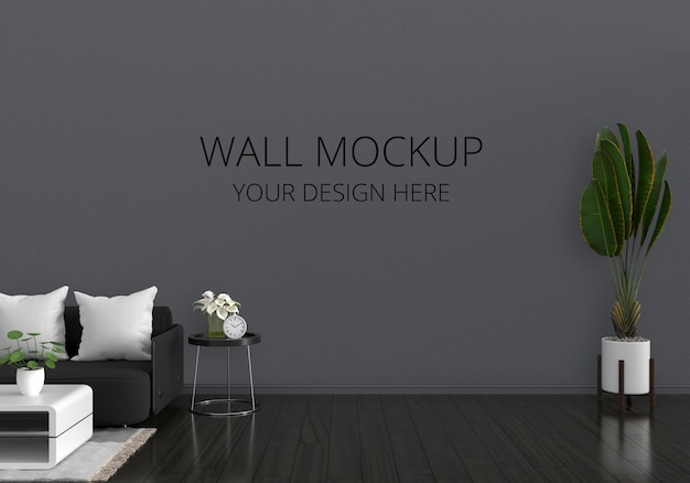 Divano nero all'interno del soggiorno con mockup a parete