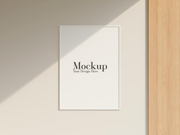 Blank frame mockup hanging on the wall with minimalist interior