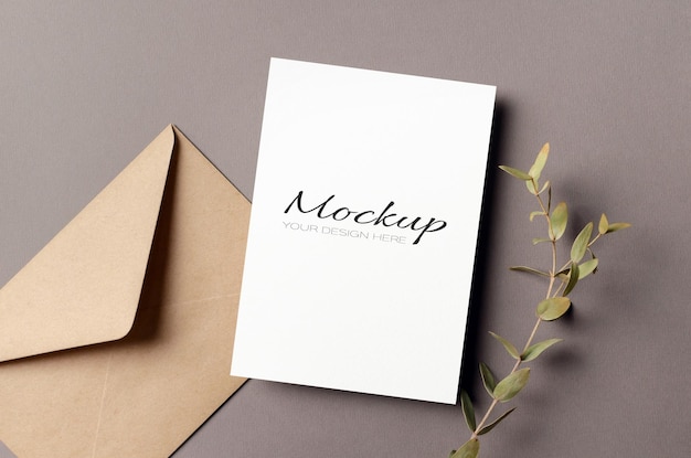 PSD blank greeting card mockup with envelope and dry eucalyptus twig