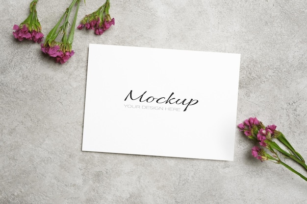 PSD blank invite card mockup with flowers decor on grey