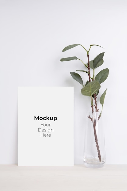 PSD blank paper sheet copy space with mockup and tree in bottle glass on wooden table