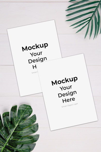 PSD blank paper sheet with mockup and leaf on wooden table