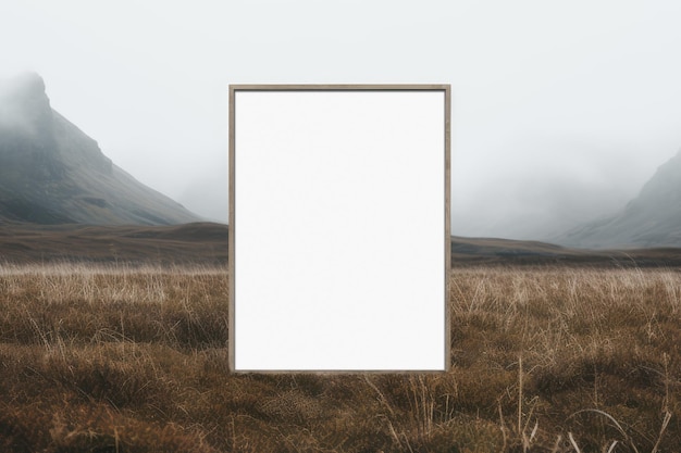 PSD blank picture frame standing in front of the cloudy mountainous background conceptual poster mockup