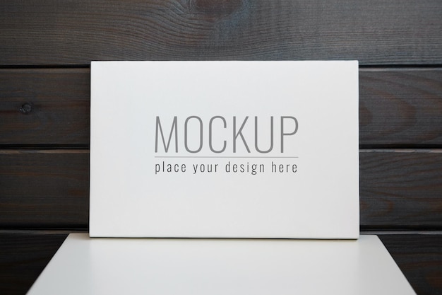 Blank stretched canvas mockup on white table