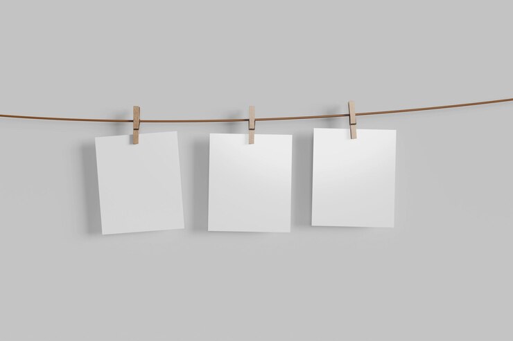 PSD blank white papers hanging on string with clothespins